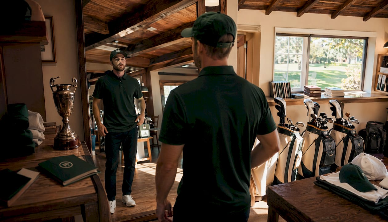 Golfer trying limited edition golf apparel in shop