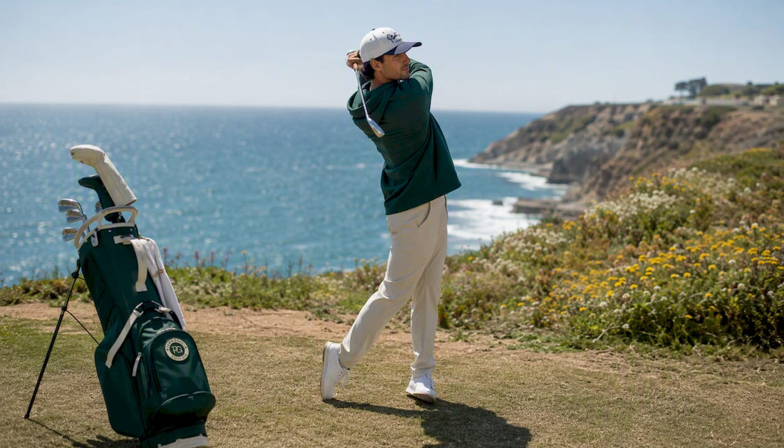 Golfer in relaxed fit sportswear swinging on golf course