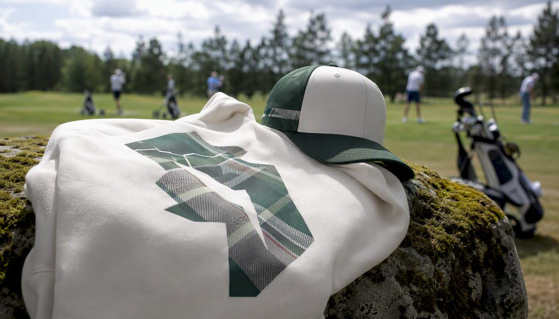 Close-up of golf hoodie chest print and hat crown