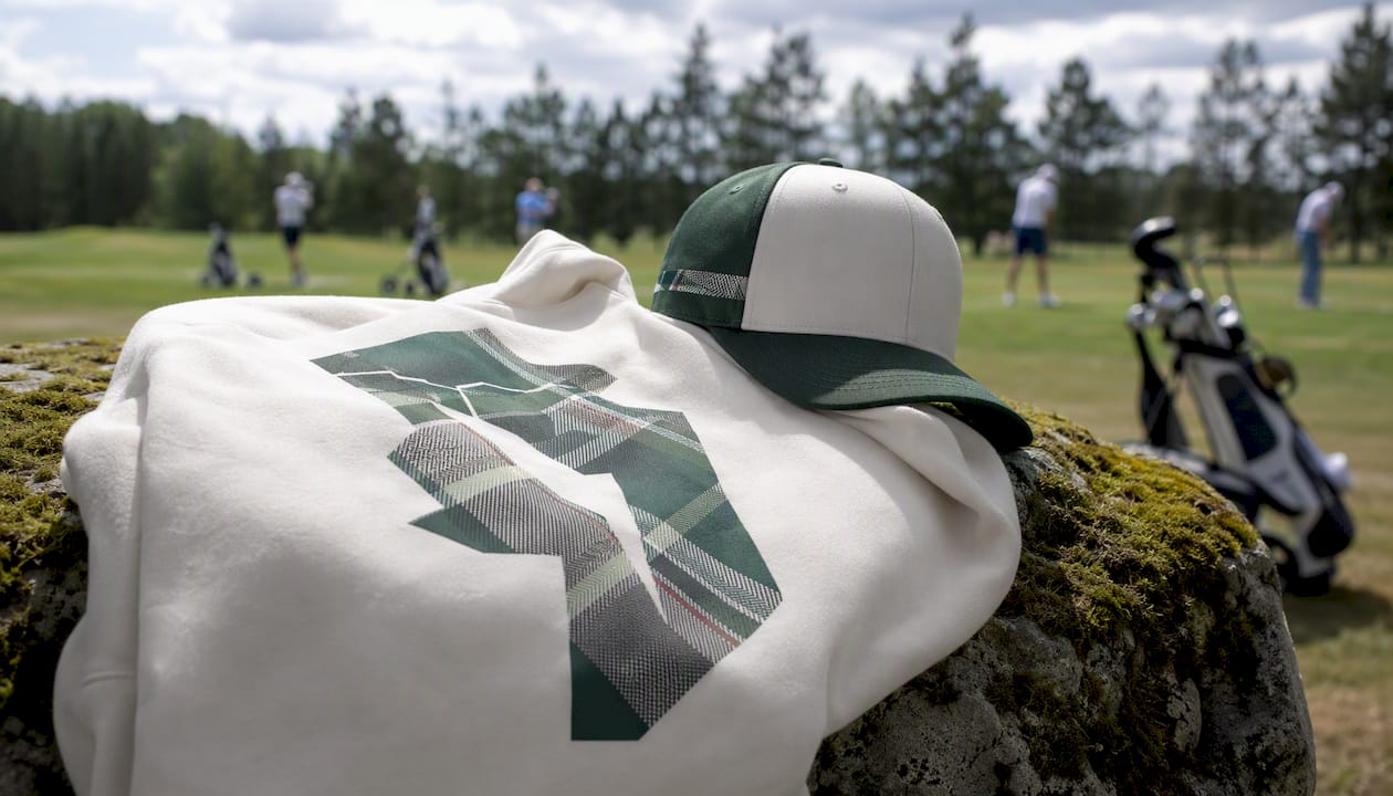 Close-up of golf hoodie chest print and hat crown