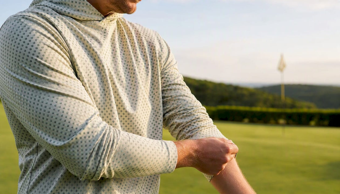 Golfer adjusting breathable golf shirt sleeve